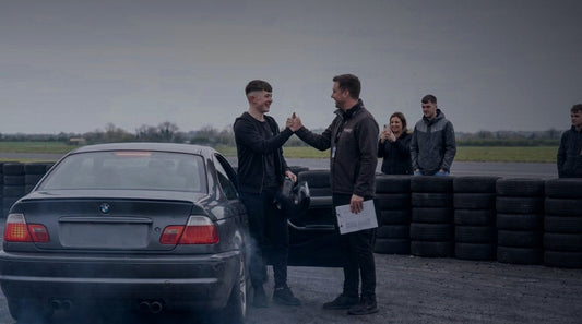 A teenager and their mentor beside a National Drift Academy car at Bishopscourt after a first drift lesson